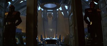 Movie still from “Judge Dredd” (1995), directed by Danny Cannon – A view of a room from the inside of a room; Extreme Wide shot, High angle