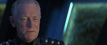 Movie still from “Judge Dredd” (1995), directed by Danny Cannon – An older man wearing a military uniform; Close Up shot, Over the shoulder angle