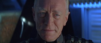 Movie still from “Judge Dredd” (1995), directed by Danny Cannon – An older man wearing a military uniform; Close Up shot, Over the shoulder angle