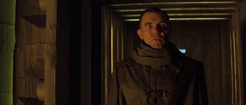 Movie still from “Judge Dredd” (1995), directed by Danny Cannon – A man in a trench coat standing next to a wall; Close Up shot, Low angle