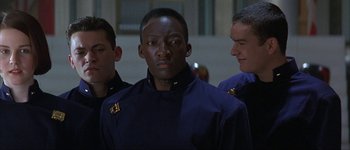 Movie still from “Judge Dredd” (1995), directed by Danny Cannon – A group of men standing next to each other in a room; Close Up shot, Low angle