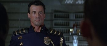 Movie still from “Judge Dredd” (1995), directed by Danny Cannon – A person wearing a uniform; Close Up shot, Low angle