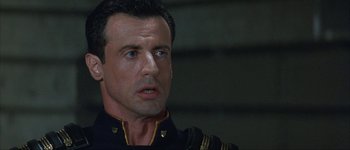 Movie still from “Judge Dredd” (1995), directed by Danny Cannon – A person wearing a uniform; Close Up shot, Low angle