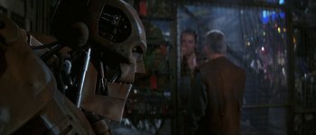 Movie still from “Judge Dredd” (1995), directed by Danny Cannon – The head of an iron man suit; Close Up shot, Over the shoulder angle