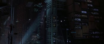 Movie still from “Judge Dredd” (1995), directed by Danny Cannon – A view of a city at night from the ground level; Extreme Wide shot, Low angle