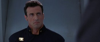 Movie still from “Judge Dredd” (1995), directed by Danny Cannon – A person wearing a uniform; Close Up shot, Low angle