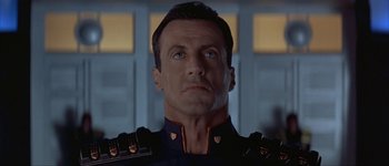 Movie still from “Judge Dredd” (1995), directed by Danny Cannon – A person wearing a uniform; Close Up shot, Low angle