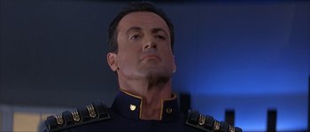 Movie still from “Judge Dredd” (1995), directed by Danny Cannon – A person wearing a uniform; Close Up shot, Low angle