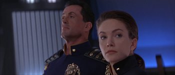Movie still from “Judge Dredd” (1995), directed by Danny Cannon – A man and a woman in military uniforms looking at the camera; Close Up shot, Low angle