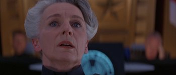 Movie still from “Judge Dredd” (1995), directed by Danny Cannon – An older woman with gray hair looking up at the sky; Close Up shot, Low angle