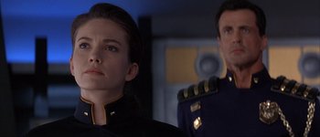 Movie still from “Judge Dredd” (1995), directed by Danny Cannon – A man and a woman are looking at the camera; Close Up shot, Low angle