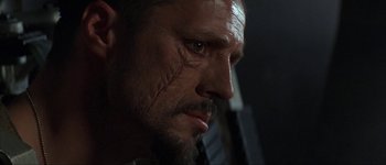 Movie still from “Judge Dredd” (1995), directed by Danny Cannon – A person with a scar on his face; Close Up shot, Low angle