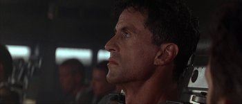 Movie still from “Judge Dredd” (1995), directed by Danny Cannon – A person looking up at something; Close Up shot, Low angle