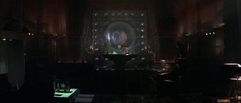 Movie still from “Judge Dredd” (1995), directed by Danny Cannon – A man sitting in front of a large mirror in a dark room; Extreme Wide shot, High angle