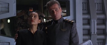 Movie still from “Judge Dredd” (1995), directed by Danny Cannon – A man and a woman standing next to each other; Close Up shot, Low angle