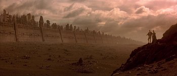 Movie still from “Judge Dredd” (1995), directed by Danny Cannon – A fence that has been built on top of the ground; Extreme Wide shot, Low angle