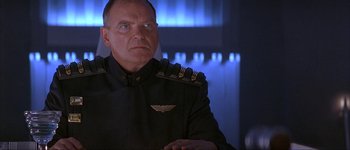 Movie still from “Judge Dredd” (1995), directed by Danny Cannon – A man in a uniform is looking at the camera; Close Up shot, Low angle