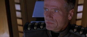 Movie still from “Judge Dredd” (1995), directed by Danny Cannon – An older man wearing a uniform looking at the camera; Close Up shot, Low angle