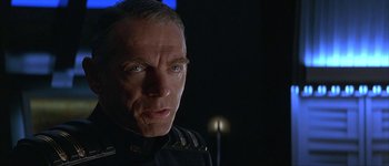 Movie still from “Judge Dredd” (1995), directed by Danny Cannon – A person wearing a uniform; Close Up shot, Low angle