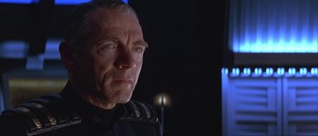 Movie still from “Judge Dredd” (1995), directed by Danny Cannon – An older man wearing a uniform looking at the camera; Close Up shot, Low angle