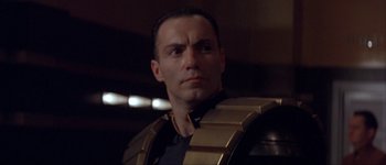 Movie still from “Judge Dredd” (1995), directed by Danny Cannon – A person wearing a suit and tie; Close Up shot, Low angle