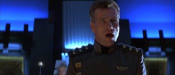 Movie still from “Judge Dredd” (1995), directed by Danny Cannon – A person wearing a uniform; Close Up shot, Low angle