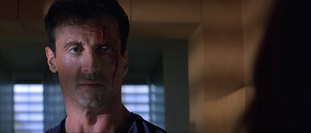 Movie still from “Judge Dredd” (1995), directed by Danny Cannon – A person with blood on his face; Close Up shot, Low angle