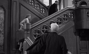 Movie still from “Judgment at Nuremberg” (1961), directed by Stanley Kramer – A man and a woman walking down a staircase; Medium shot, Low angle