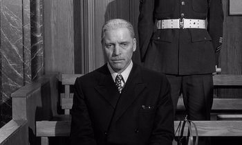 Movie still from “Judgment at Nuremberg” (1961), directed by Stanley Kramer – An older man wearing a suit and tie; Medium shot, Low angle