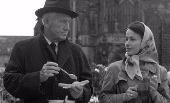 Movie still from “Judgment at Nuremberg” (1961), directed by Stanley Kramer – An older man and a young woman are having a conversation; Medium shot, Over the shoulder angle