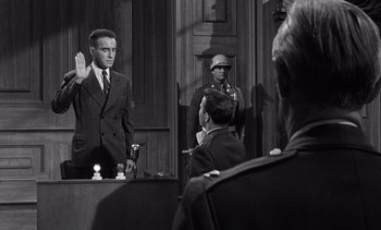 Movie still from “Judgment at Nuremberg” (1961), directed by Stanley Kramer – A man is being sworn in by a judge; Medium shot, Over the shoulder angle