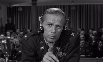 Movie still from “Judgment at Nuremberg” (1961), directed by Stanley Kramer – An older man in a military uniform wearing headphones; Close Up shot, Low angle