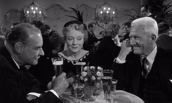Movie still from “Judgment at Nuremberg” (1961), directed by Stanley Kramer – A black and white photo of a group of people sitting at a table; Medium shot, Over the shoulder angle