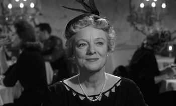 Movie still from “Judgment at Nuremberg” (1961), directed by Stanley Kramer – An older woman wearing a black dress and a hat; Close Up shot, Low angle