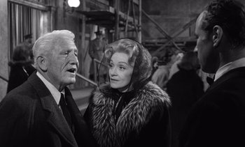 Movie still from “Judgment at Nuremberg” (1961), directed by Stanley Kramer – An older man and a younger woman are talking to each other; Medium shot, Over the shoulder angle