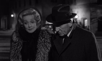 Movie still from “Judgment at Nuremberg” (1961), directed by Stanley Kramer – An older man and a younger woman standing next to each other; Close Up shot, Over the shoulder angle