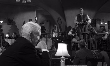 Movie still from “Judgment at Nuremberg” (1961), directed by Stanley Kramer – An older man sitting in front of a group of people; Medium shot, Over the shoulder angle