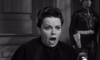Movie still from “Judgment at Nuremberg” (1961), directed by Stanley Kramer – An old photo of a woman with an angry look on her face; Close Up shot, High angle