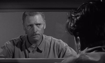 Movie still from “Judgment at Nuremberg” (1961), directed by Stanley Kramer – A black and white photo of a man looking in the mirror; Close Up shot, Over the shoulder angle