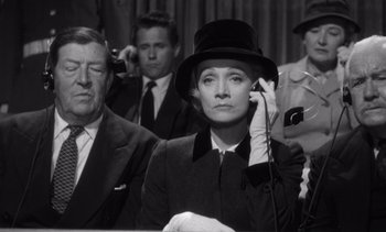 Movie still from “Judgment at Nuremberg” (1961), directed by Stanley Kramer – An old photo of a woman talking on a phone; Medium shot, High angle