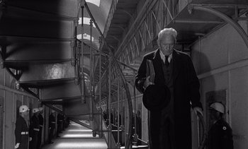 Movie still from “Judgment at Nuremberg” (1961), directed by Stanley Kramer – An old man walking down the stairs of a train; Medium shot, Low angle