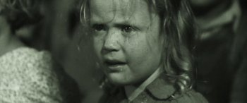 Movie still from “Judy & Punch” (2019), directed by Mirrah Foulkes – A little girl with a sad look on her face; Close Up shot, High angle
