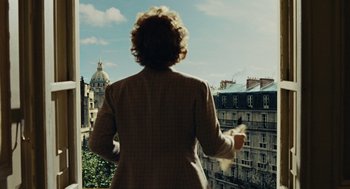 Movie still from “Julie & Julia” (2009), directed by Nora Ephron – A woman standing on a balcony looking out over a city; Medium shot, Low angle