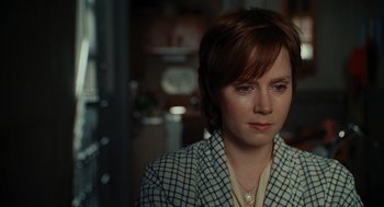 Movie still from “Julie & Julia” (2009), directed by Nora Ephron – A woman with short red hair wearing a checkered jacket; Close Up shot, Over the shoulder angle