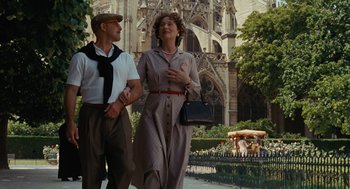 Movie still from “Julie & Julia” (2009), directed by Nora Ephron – A man and a woman walking down a street; Medium shot, Low angle