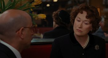 Movie still from “Julie & Julia” (2009), directed by Nora Ephron – An older woman sitting at a table in a restaurant; Close Up shot, Over the shoulder angle