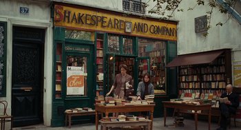 Movie still from “Julie & Julia” (2009), directed by Nora Ephron – Two people standing outside of shakespeare and company bookstore; Wide shot, High angle