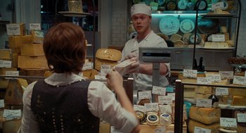 Movie still from “Julie & Julia” (2009), directed by Nora Ephron – A man and a woman in a bakery shop; Medium shot, Over the shoulder angle