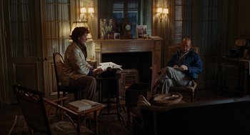 Movie still from “Julie & Julia” (2009), directed by Nora Ephron – A man and a woman are sitting in a living room; Wide shot, High angle