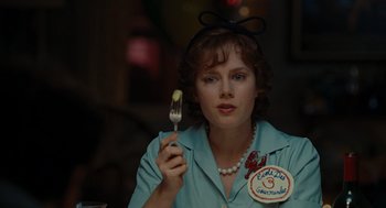 Movie still from “Julie & Julia” (2009), directed by Nora Ephron – A woman holding a fork in her right hand; Close Up shot, Over the shoulder angle